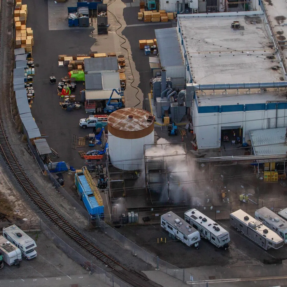 An aerial view of water being sprayed onto an overheated tank at GKN Aerospace on May 23.