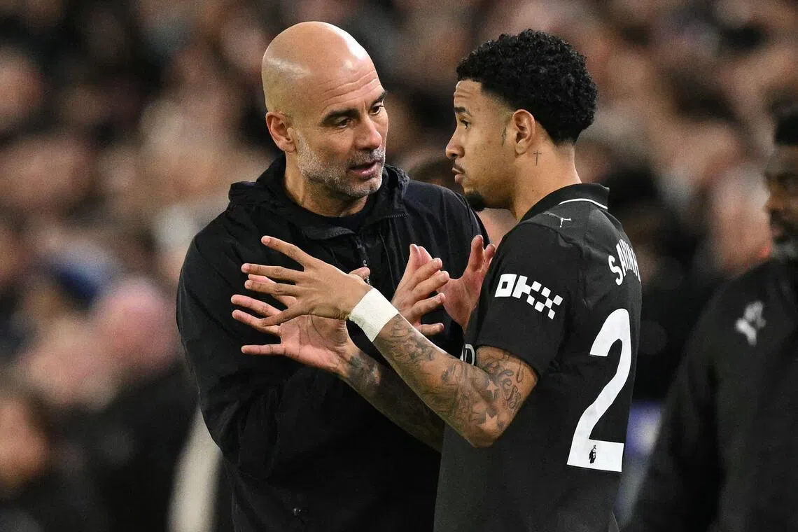 Manchester City manager Pep Guardiola speaks with Savinho during the Premier League match against Leeds United.