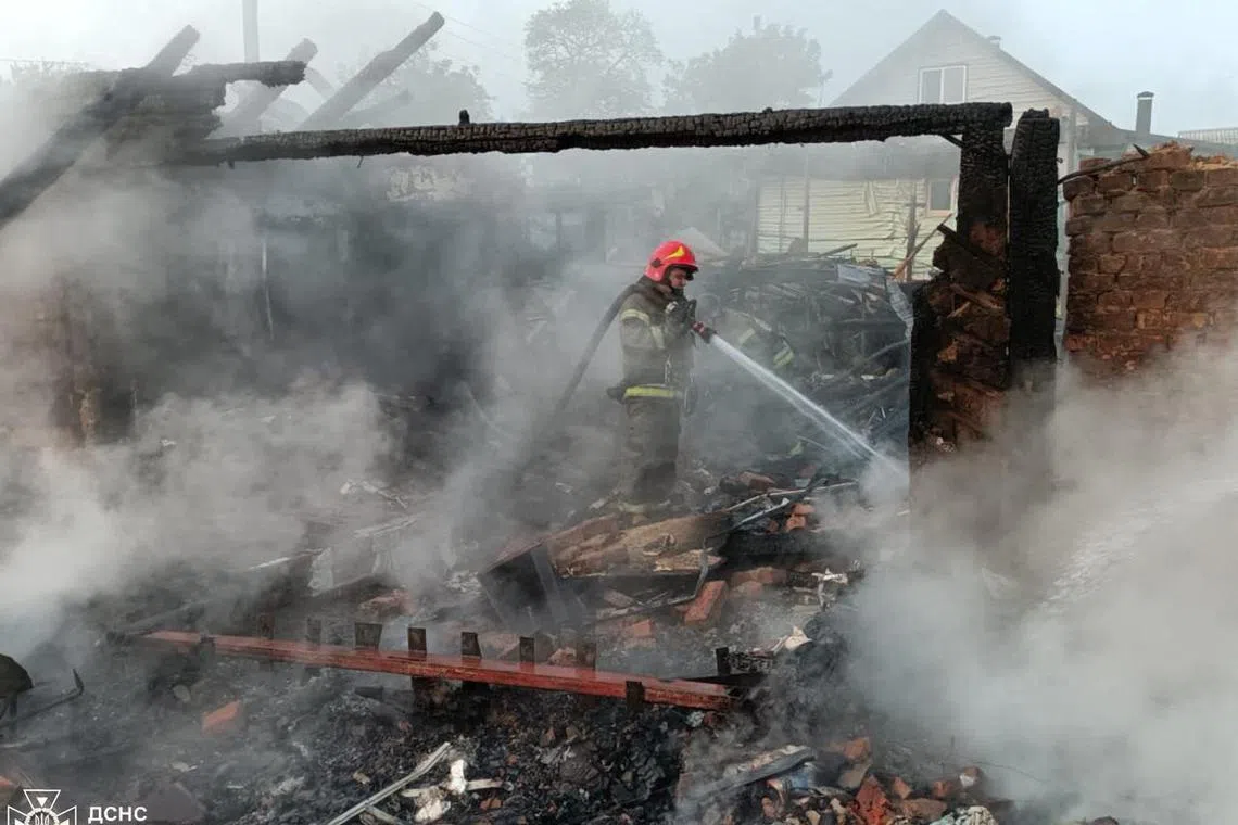 A firefighter working at the site of a Russian drone strike in the town of Pryluky, in Ukraine's Chernihiv region, on June 5.