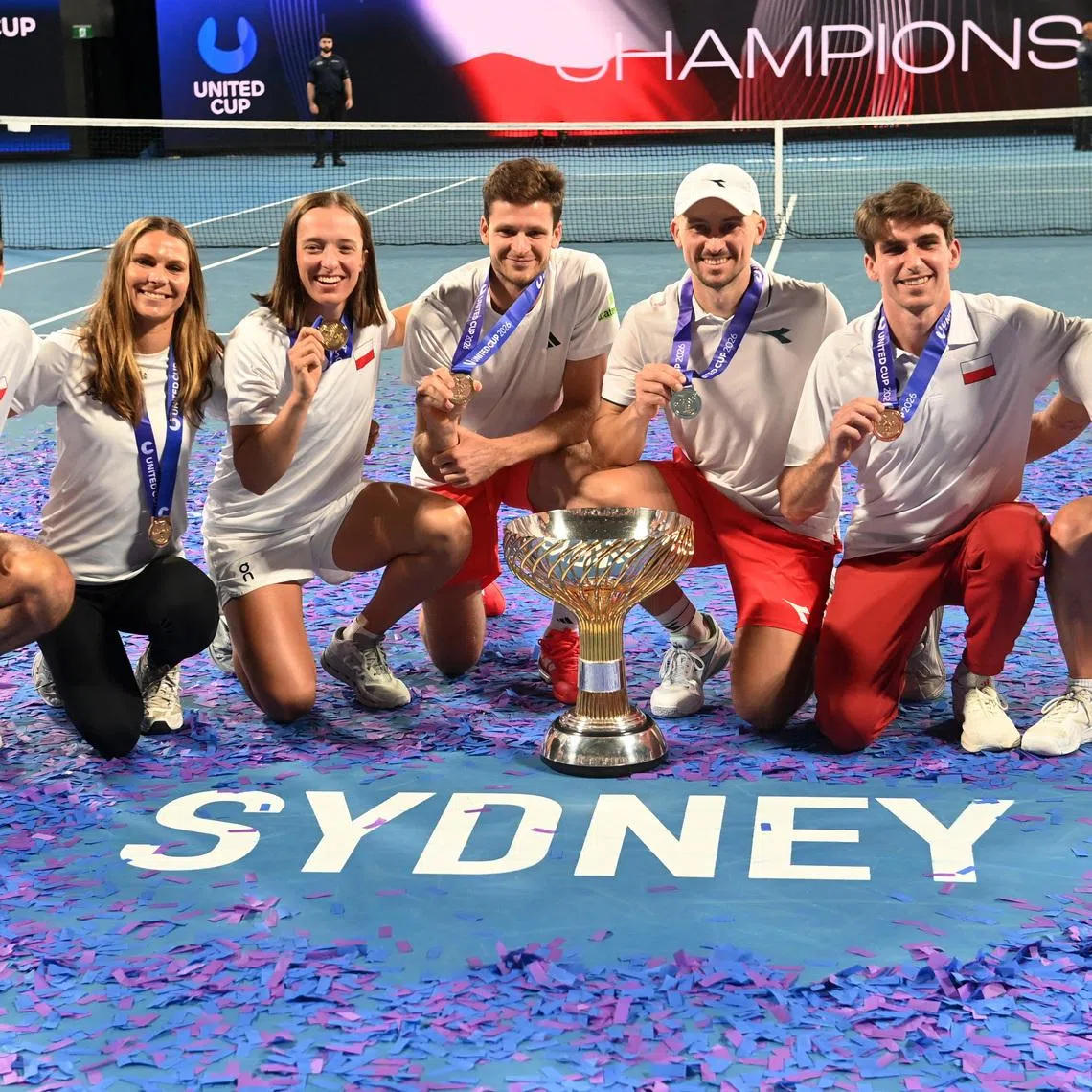 Tennis - United Cup - Final - Poland v Switzerland - Ken Rosewall Arena, Sydney, Australia - January 12, 2026 Poland players celebrate with the trophy after winning the United Cup REUTERS/Jeremy Piper