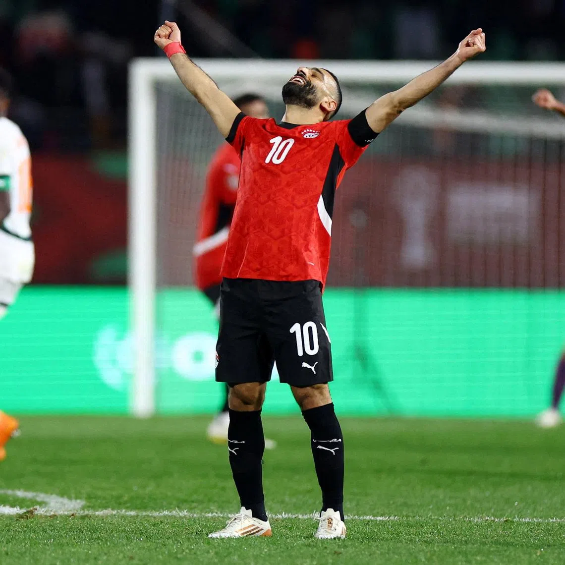Mohamed Salah raises his arms in celebration after Egypt edged out holder Ivory Coast to reach the Afcon semi-finals.