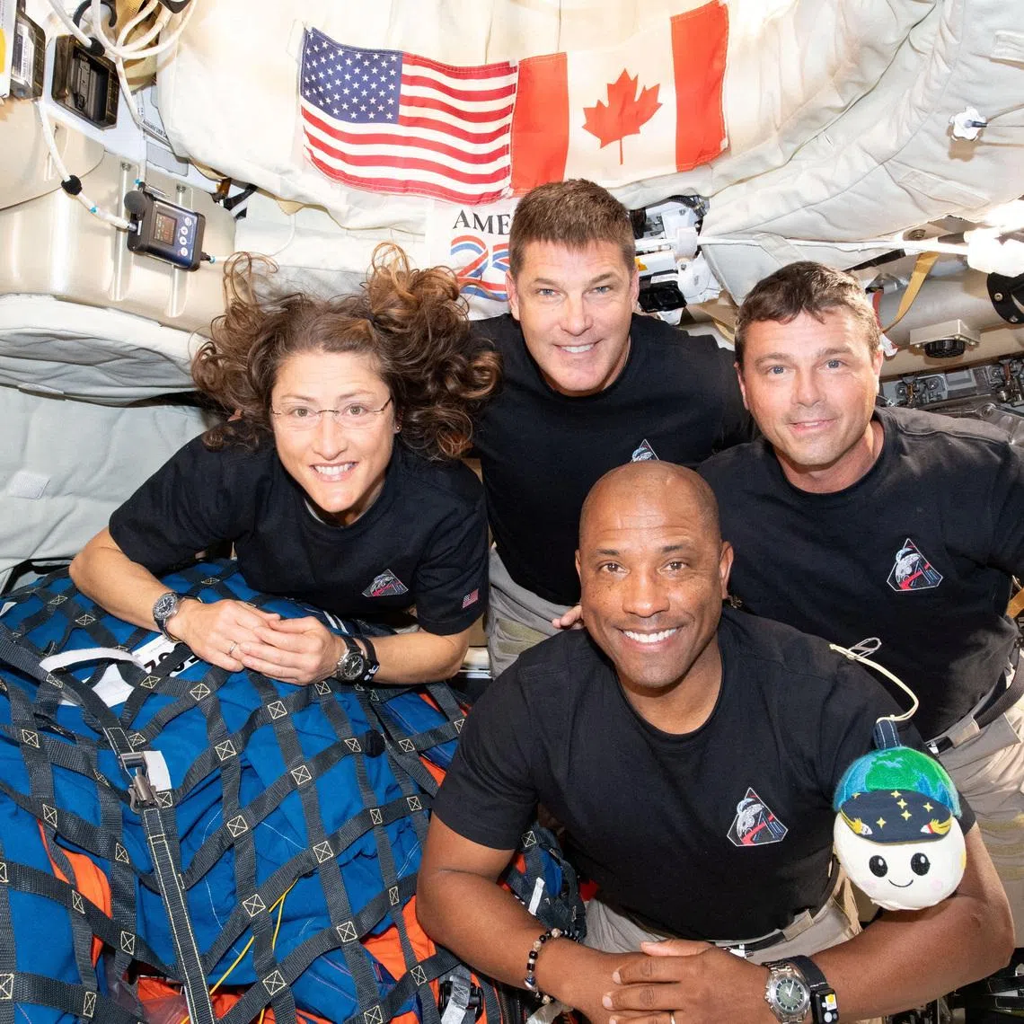 The NASA Artemis II crew, Mission Specialist Christina Koch, Mission Specialist Jeremy Hansen, Commander Reid Wiseman, and Pilot Victor Glover, pose for a group photo inside the Orion spacecraft on their way home following a flyby of the far side of the Moon on April 6, 2026. NASA/Handout via REUTERS