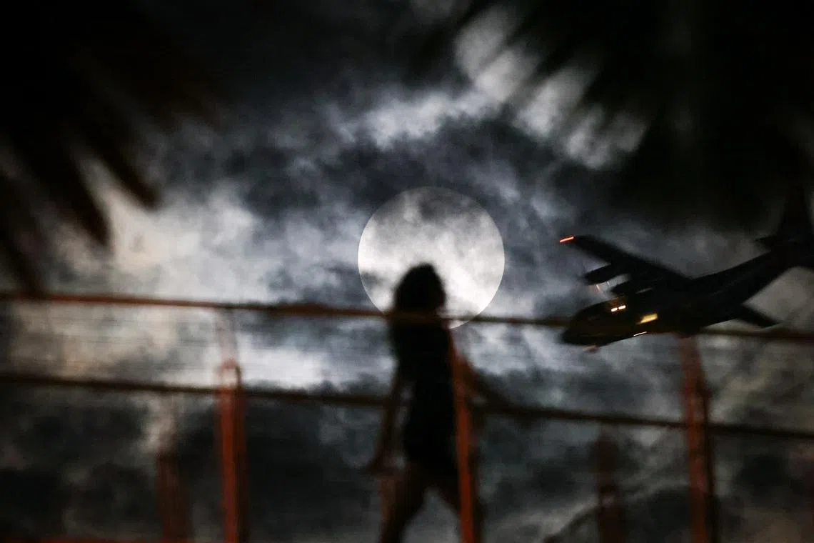 The glowing Harvest Moon seen from Gardens by the Bay on Sept 18, 2024, delighted skygazers in Singapore, even as visibility of the supermoon was at times obscured by clouds.