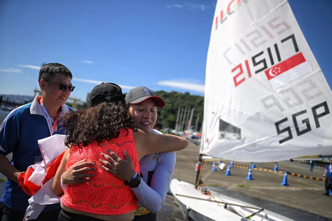 Jania Ang of Singapore hugs her parents after the Women?s Dinghy ILCA 6 final at the Kaiyoh Yacht Harbour on Oct 2, 2026.