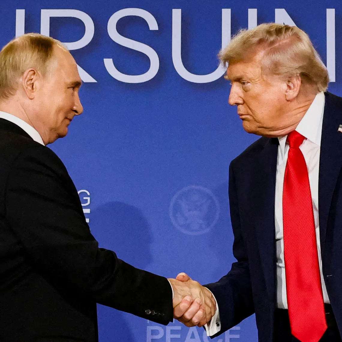 US President Donald Trump and Russian President Vladimir Putin shake hands at a press conference following their meeting in Anchorage, Alaska, US, on Aug 15.