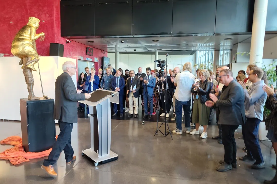Danish artist Jens Galschiot unveils Orange Plague before reporters at the European Parliament building in Strasbourg, Germany.