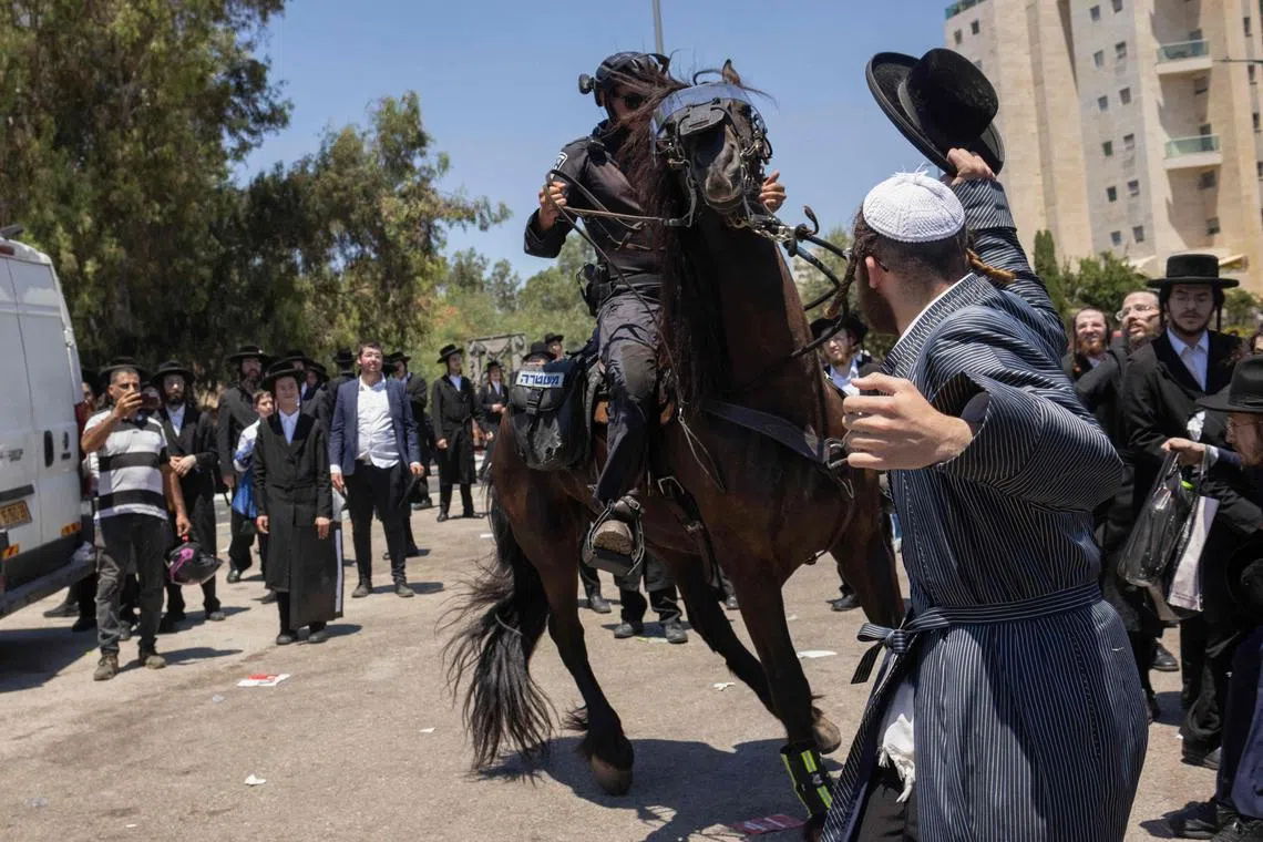 Israeli mounted police deploy as ultra-Orthodox protesters demonstrate outside the Tel Hashomer army base, near Tel Aviv.