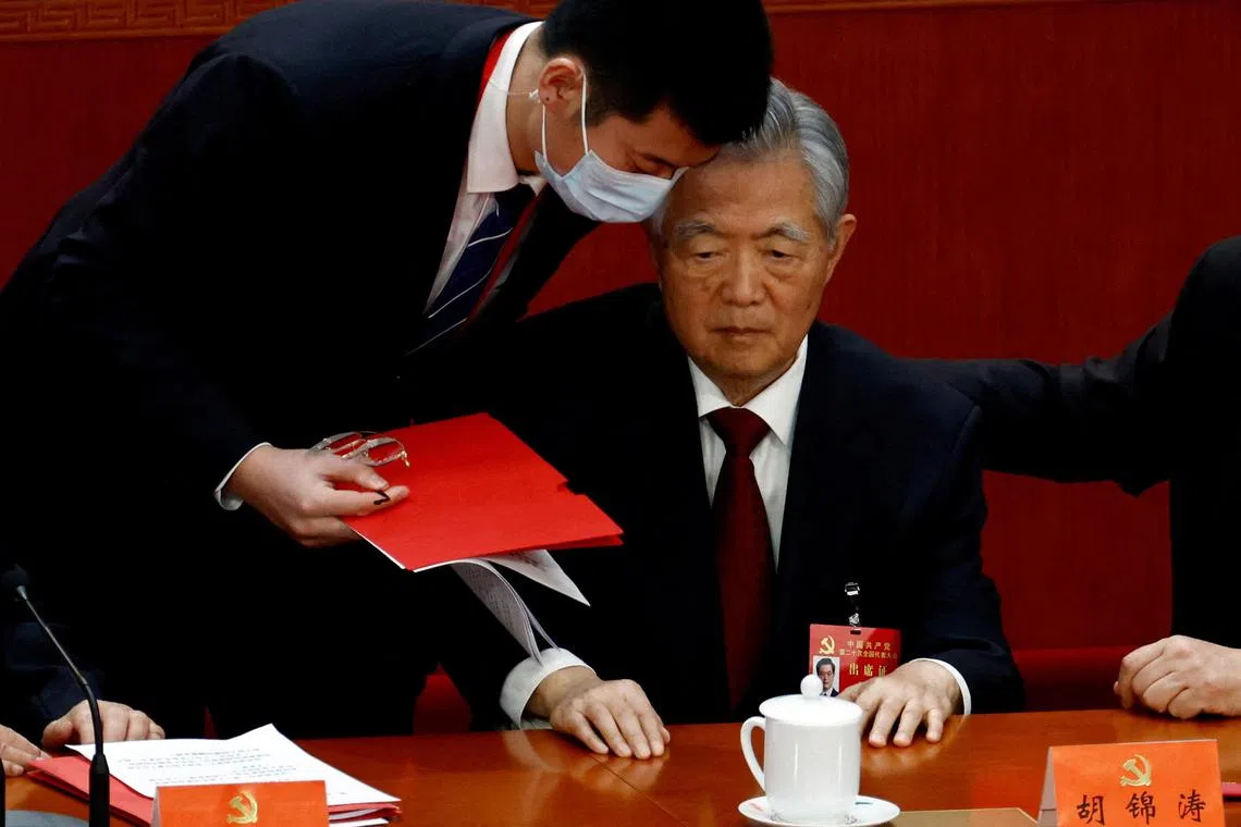 Mr Hu Jintao is assisted at his seat during the 20th National Congress of the Communist Party of China on oct 22, 2022.