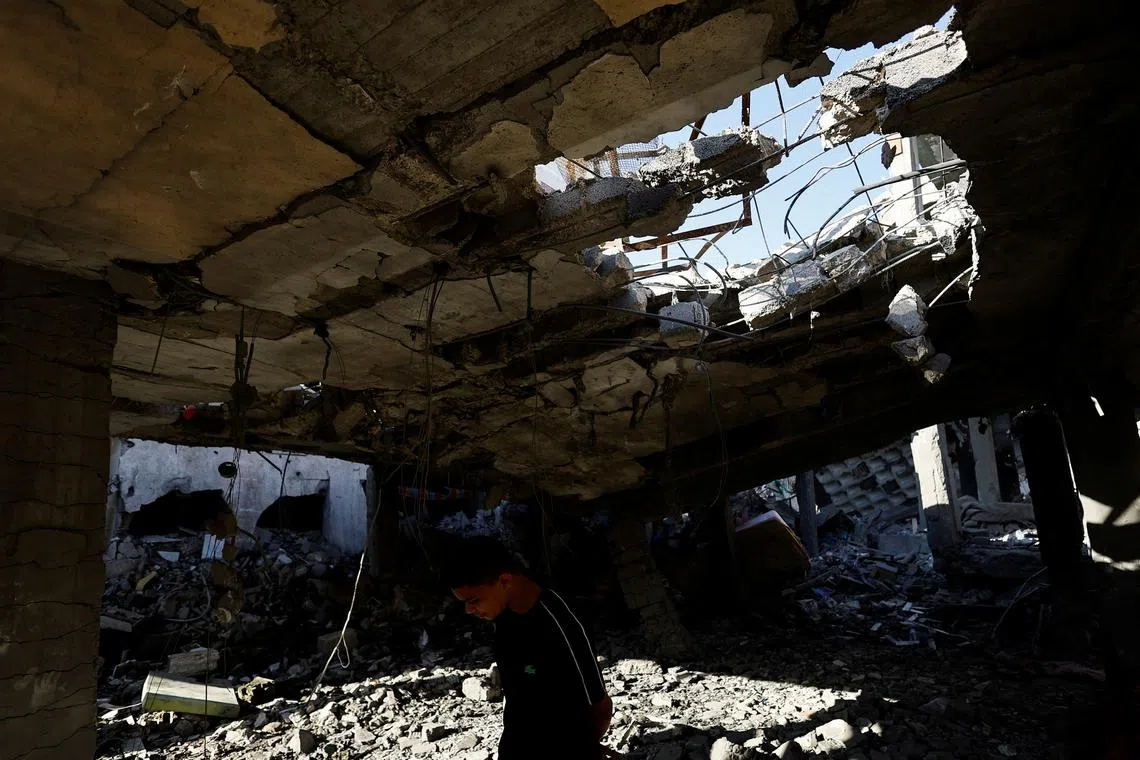 A Palestinian boy inspects the site of an Israeli strike on a house, amid the ongoing conflict between Israel and the Palestinian Islamist group Hamas, in Rafah, in the southern Gaza Strip, April 17, 2024. REUTERS/Mohammed Salem