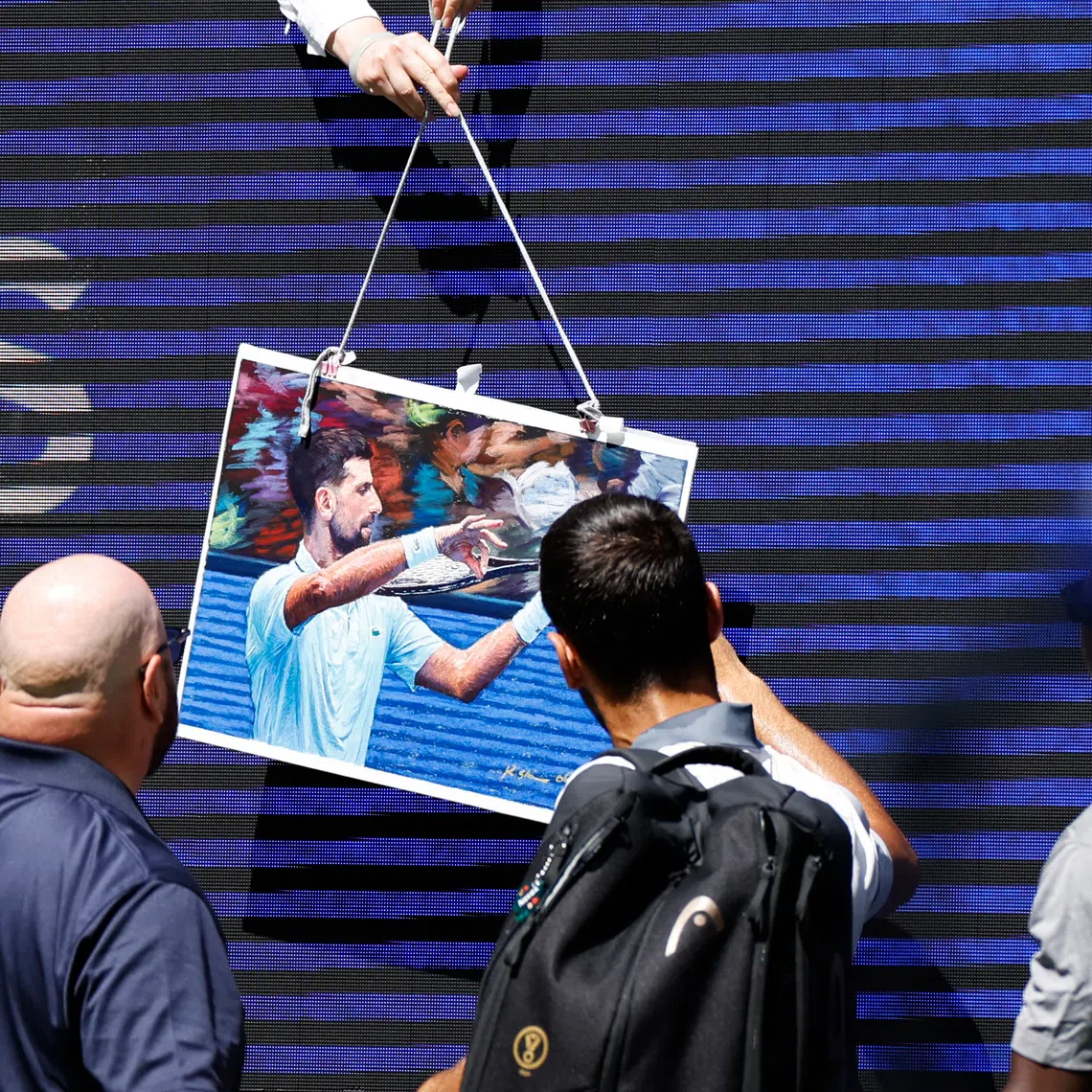 Tennis - U.S. Open - Flushing Meadows, New York, United States - August 25, 2026 Serbia's Novak Djokovic signs autographs for fans after his mixed doubles round of 16 match with Belarus' Aryna Sabalenka against Britain's Henry Patten and Czech Republic's Katerina Siniakova REUTERS/Eduardo Munoz