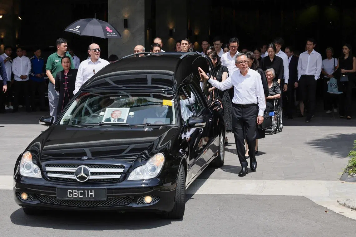 Family members and friends following behind in procession as the hearse bearing the body of Dr. Wee Cho Yaw departs from Woodlands Memorial on Feb 7, 2024.
