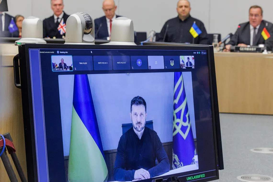 Ukrainian President Volodymyr Zelensky (on screen) addressing a meeting of defence ministers in Brussels on June 4.