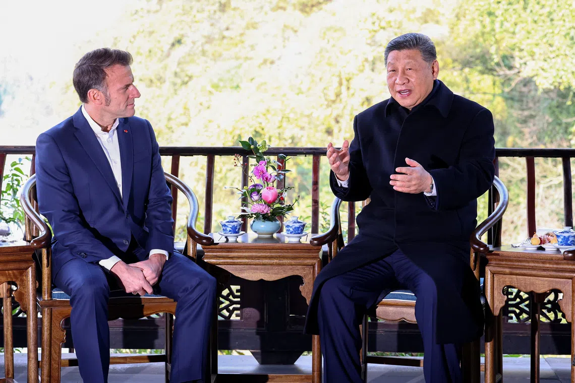 French President Emmanuel Macron and Chinese President Xi Jinping speak during a visit to the Dujiangyan site, designated a UNESCO World Heritage Site, in Dujiangyan, Sichuan province, as part of Macron's three-day visit to China, December 5, 2025. REUTERS/Sarah Meyssonnier/Pool