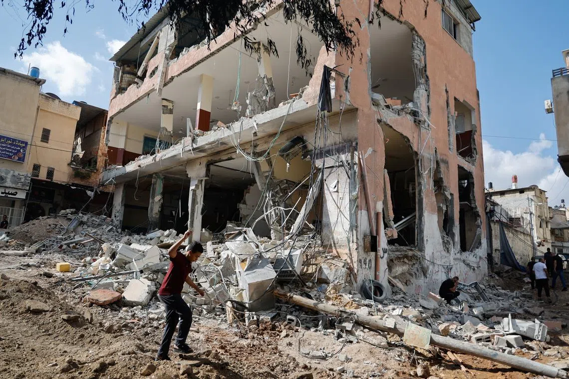A boy seen at the site of a building damaged during an Israeli raid in Tulkarm, West Bank, on Oct 20.