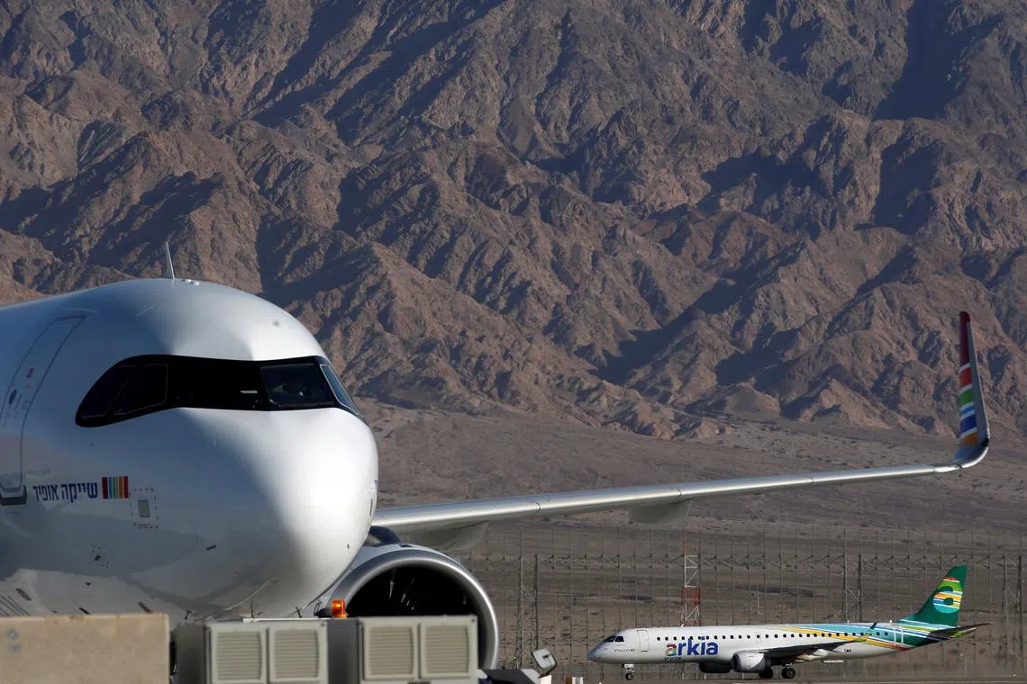 FILE PHOTO: An Arkia Israeli Airlines Embraer plane is seen in the background at Ramon International Airport in Israel January 21, 2019. REUTERS/Ronen Zvulun/File Photo