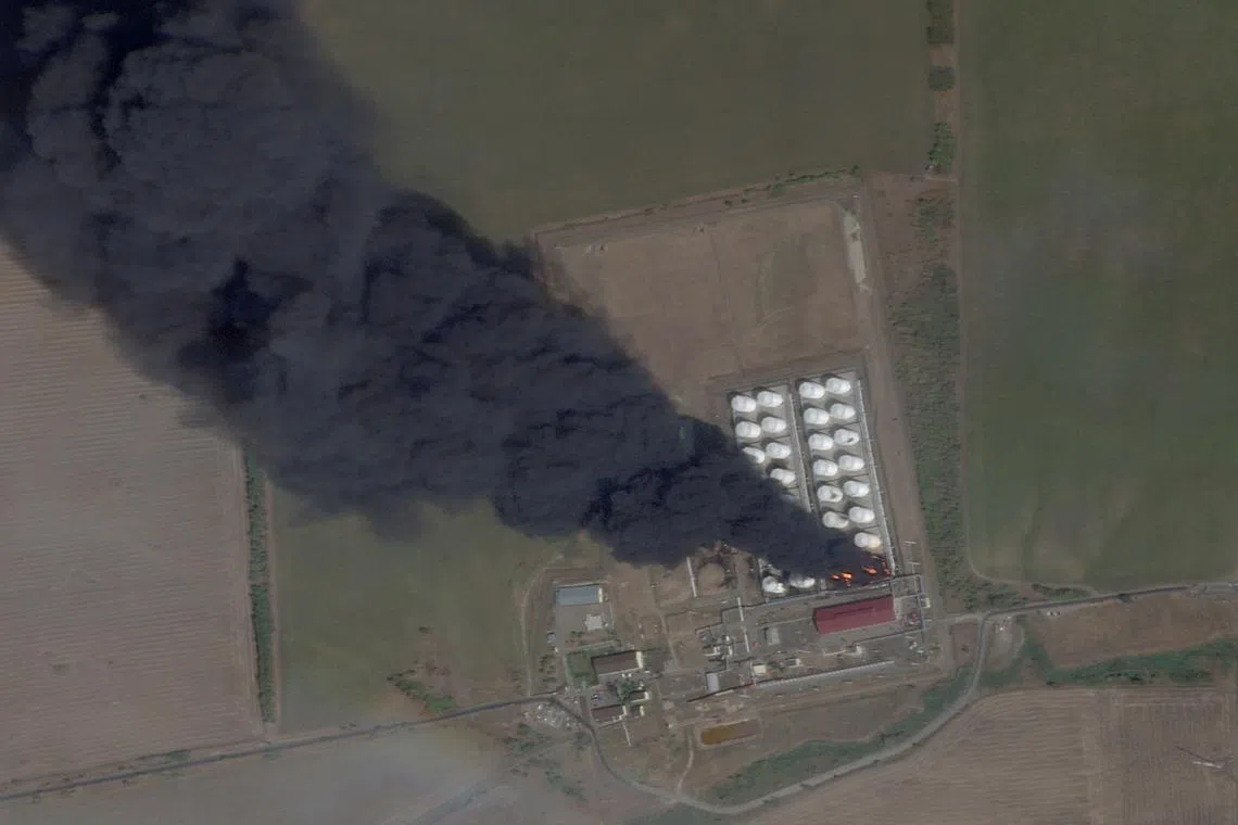 A satellite image shows smoke and fire rising from an oil depot, amid the ongoing conflict between Russia and Ukraine, at Astakhov in the Kamensky district, Rostov Region, Russia, August 28, 2024. 2024 Planet Labs Inc./Handout via REUTERS