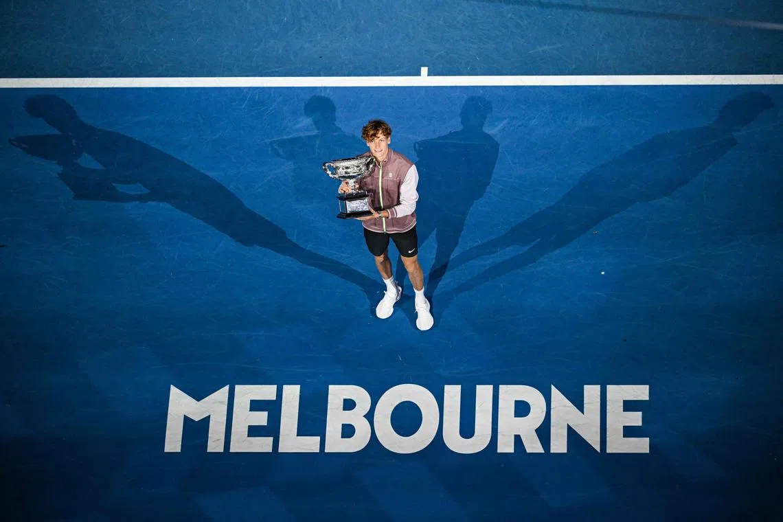 Italy's Jannik Sinner celebrates with the Norman Brookes Challenge Cup trophy after defeating Russia's Daniil Medvedev in the men's singles final match at the Australian Open.
