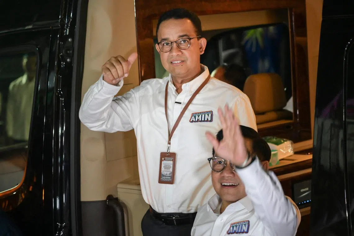 Vice presidential candidate Muhaimin Iskandar (R) and presidential candidate Anies Baswedan react as they arrive for the drawing of the ballot numbers for presidential and vice presidential candidates at the General Elections Commission (KPU) office in Jakarta on November 14, 2023. Indonesia's election commission on November 13, 2023 announced the candidates for next year's presidential vote when the world's third largest democracy is due to pick its successor to incumbent leader Joko Widodo. (Photo by Bay ISMOYO / AFP)