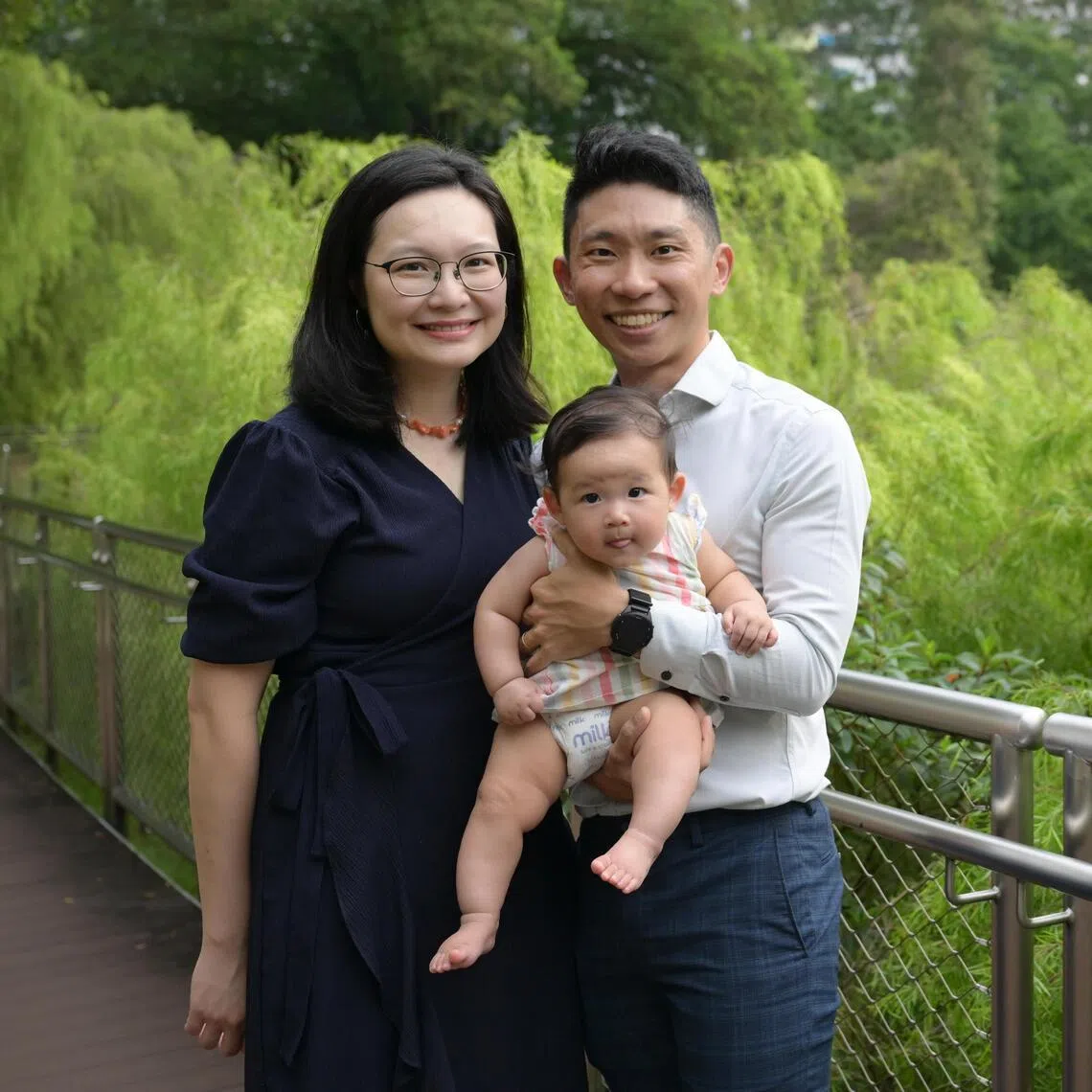 Mervin Tee and his wife, Cindy Chan, both research assistants at the NUS Saw Swee Hock School of Public Health, with their six-month-old daughter, Charlotte. Tee overcame a disadvantaged upbringing to earn his doctorate.