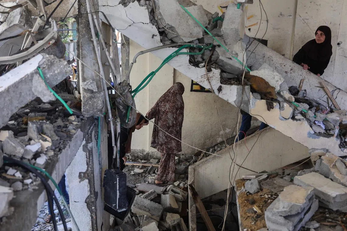 Palestinians inspecting the damage after an overnight Israeli strike on the Gaza City neighbourhood of Al-Daraj, on June 11.