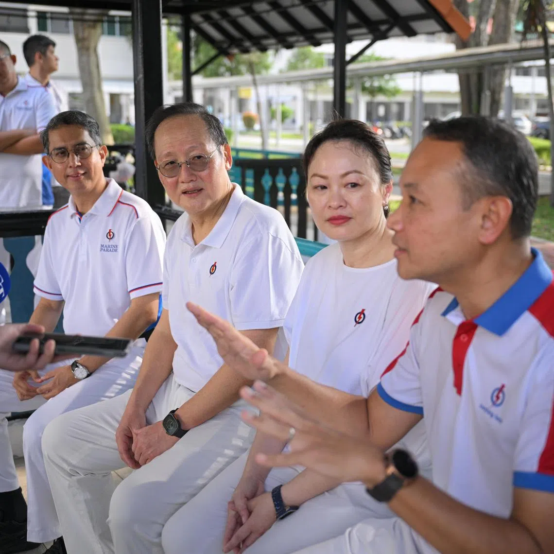(PLS NOTE: THIS IS AN ST EXCLUSIVE. PLS CHECK WITH JOYCE LIM BEFORE SHARING TO OTHER PUBS) Marine Parade MP Tan See Leng (second from left), accompanied by (from left) Associate Professor Muhammad Faishal Ibrahim, an MP at Nee Soon GRC, Diana Pang, the chairman of Fengshan Women's Executive Committee and People?s Association Women's Integration Network (WIN) Council and incumbent MP for Geylang Serai ward Fahmi Aliman, gives a doorstop to The Straits Times behind the PAP Geylang Serai branch before they visited Eunos Crescent Market and Food Centre on March 30, 2025.