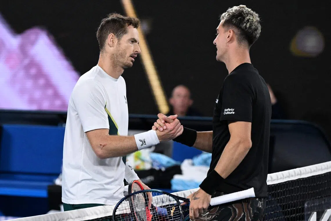 Britain's Andy Murray (L) greets Australia's Thanasi Kokkinakis after winning their men's singles match on day four of the Australian Open tennis tournament in Melbourne on January 20, 2023. (Photo by WILLIAM WEST / AFP) / -- IMAGE RESTRICTED TO EDITORIAL USE - STRICTLY NO COMMERCIAL USE --