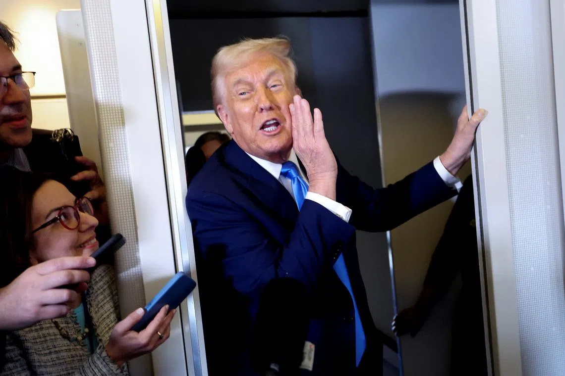 U.S. President Donald Trump speaks to members of the media aboard Air Force One before landing in West Palm Beach, Florida, U.S., March 28, 2025. REUTERS/Kevin Lamarque