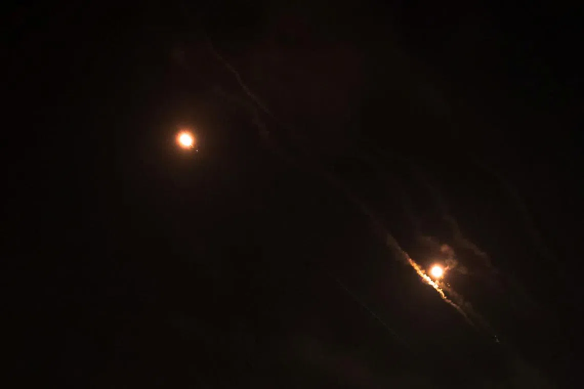 FILE PHOTO: Objects are seen in the sky above Jerusalem after Iran launched drones and missiles towards Israel, in Jerusalem April 14, 2024. REUTERS/Ronen Zvulun/File Photo