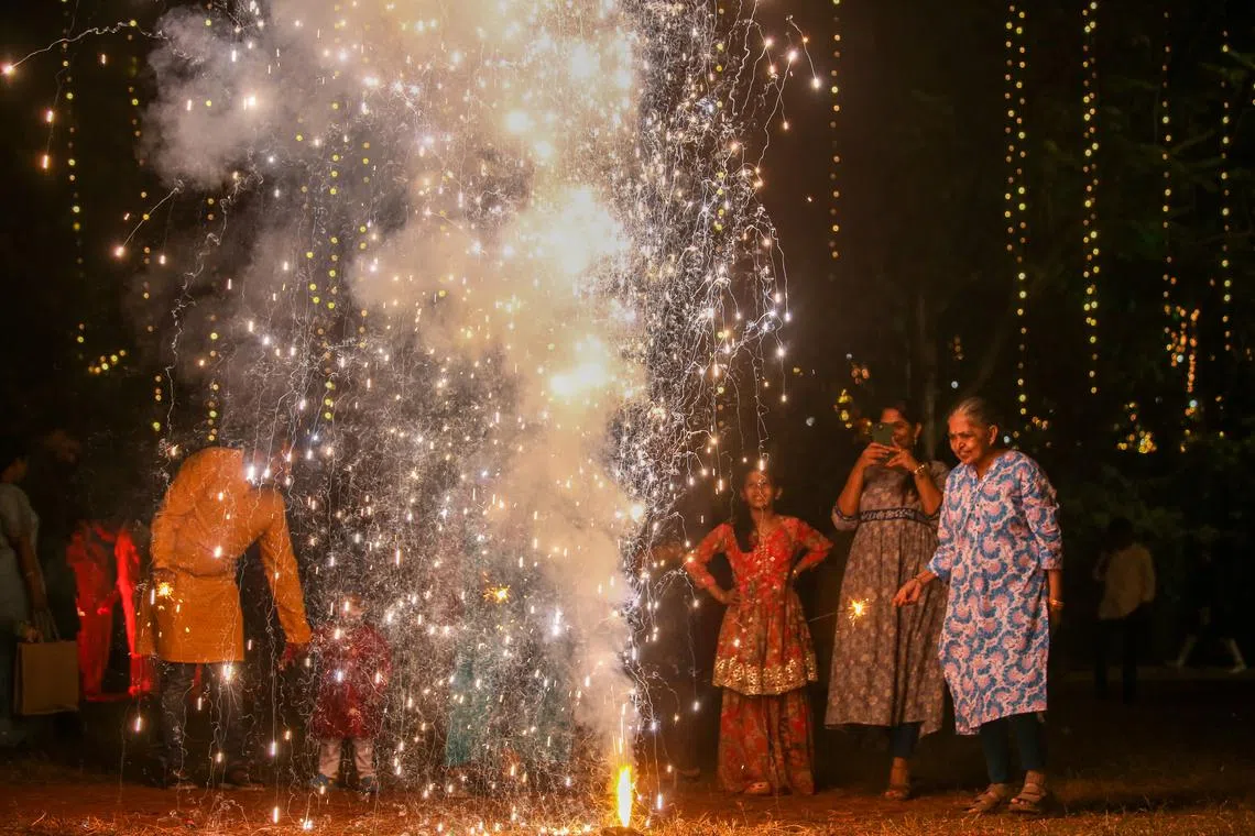 People lighting firecrackers on the occasion of the Diwali festival in Mumbai, India on Nov 12, 2023. 