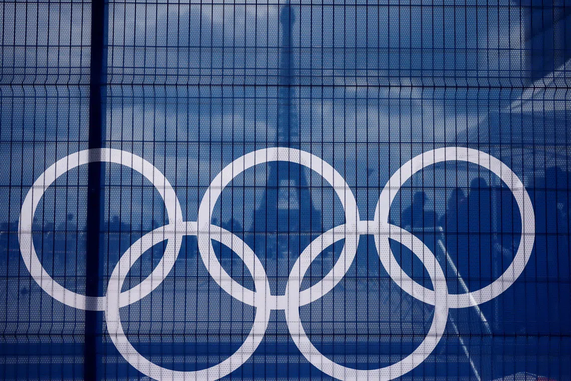 The Eiffel Tower is seen through a net with a part of the logo of the Paris 2024 Olympic and Paralympic Games from the Trocadero square in Paris, France, July 3, 2024. REUTERS/Yara Nardi