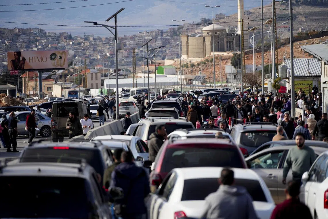 People make their way as they attempt to cross into Lebanon at the Masnaa border crossing between the Lebanon and Syria, after Syrian rebels announced that they have ousted Syria's Bashar al-Assad, as pictured from the Syrian side December 9, 2024. REUTERS/Mohammed Yassin/File Photo