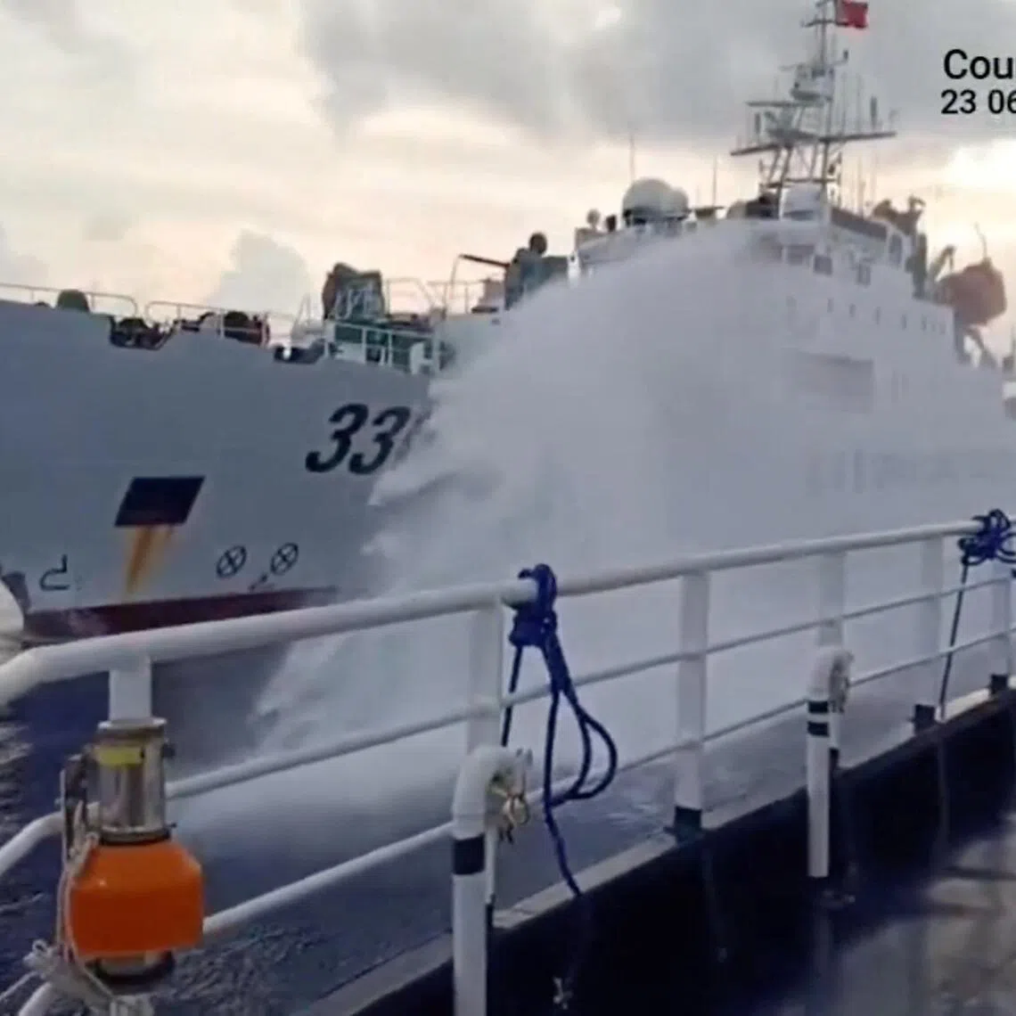 A video screengrab released on July 23 shows a Chinese coast guard ship firing a water cannon at a Philippine vessel, in a location given as South China Sea.