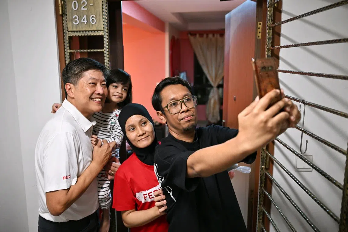 NTUC secretary-general Ng Chee Meng (left) taking a wefie with residents at Sengkang West on March 28.