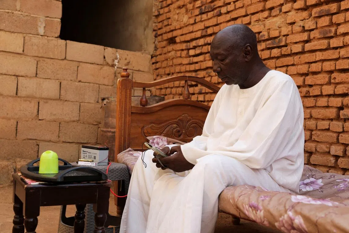 Retired Police Major General Kahil Mohamed Al-Amin, whose son was slaughtered by the Rapid Support Forces (RSF), sits on a bed during an interview, in the Salha area, south of Omdurman, Sudan, June 7, 2026. REUTERS/Stringer