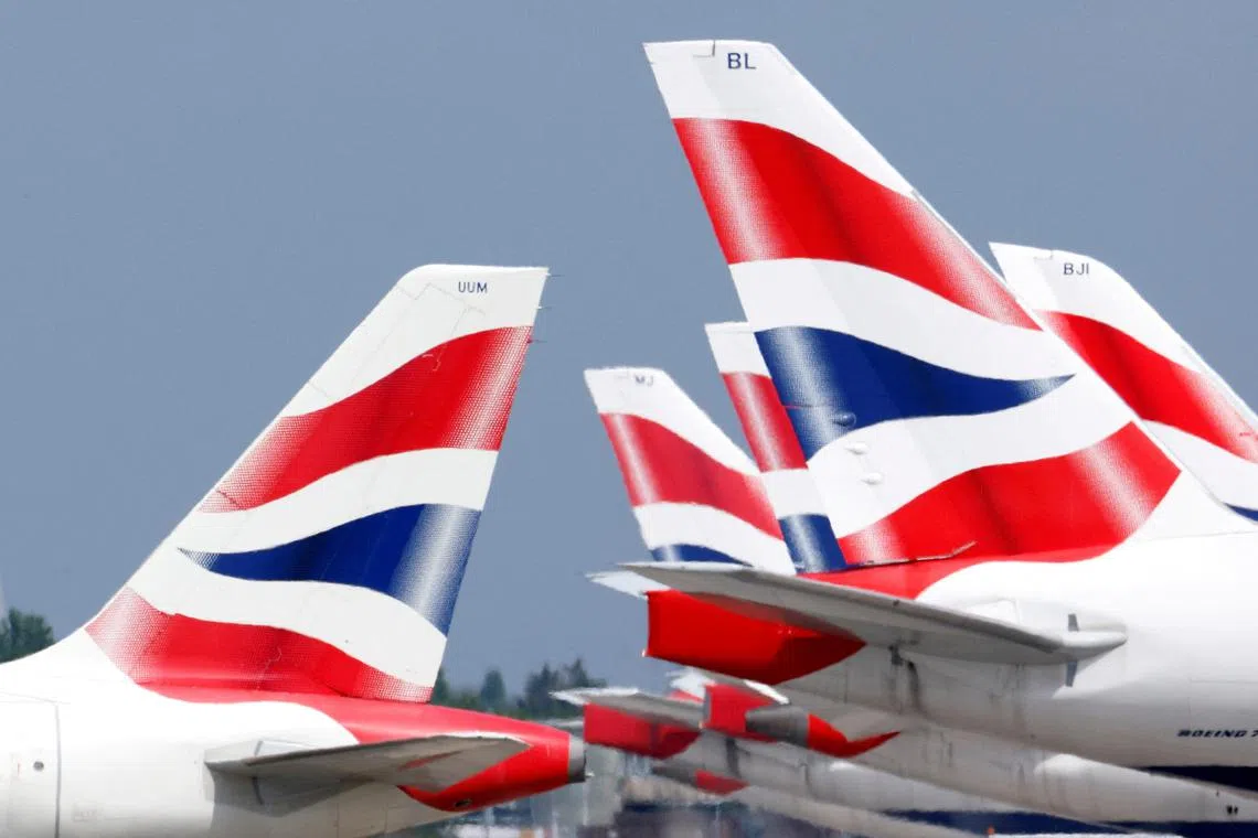 FILE PHOTO: British Airways tail fins are pictured at Heathrow Airport in London, Britain, May 17, 2021. REUTERS/John Sibley/File Photo/File Photo