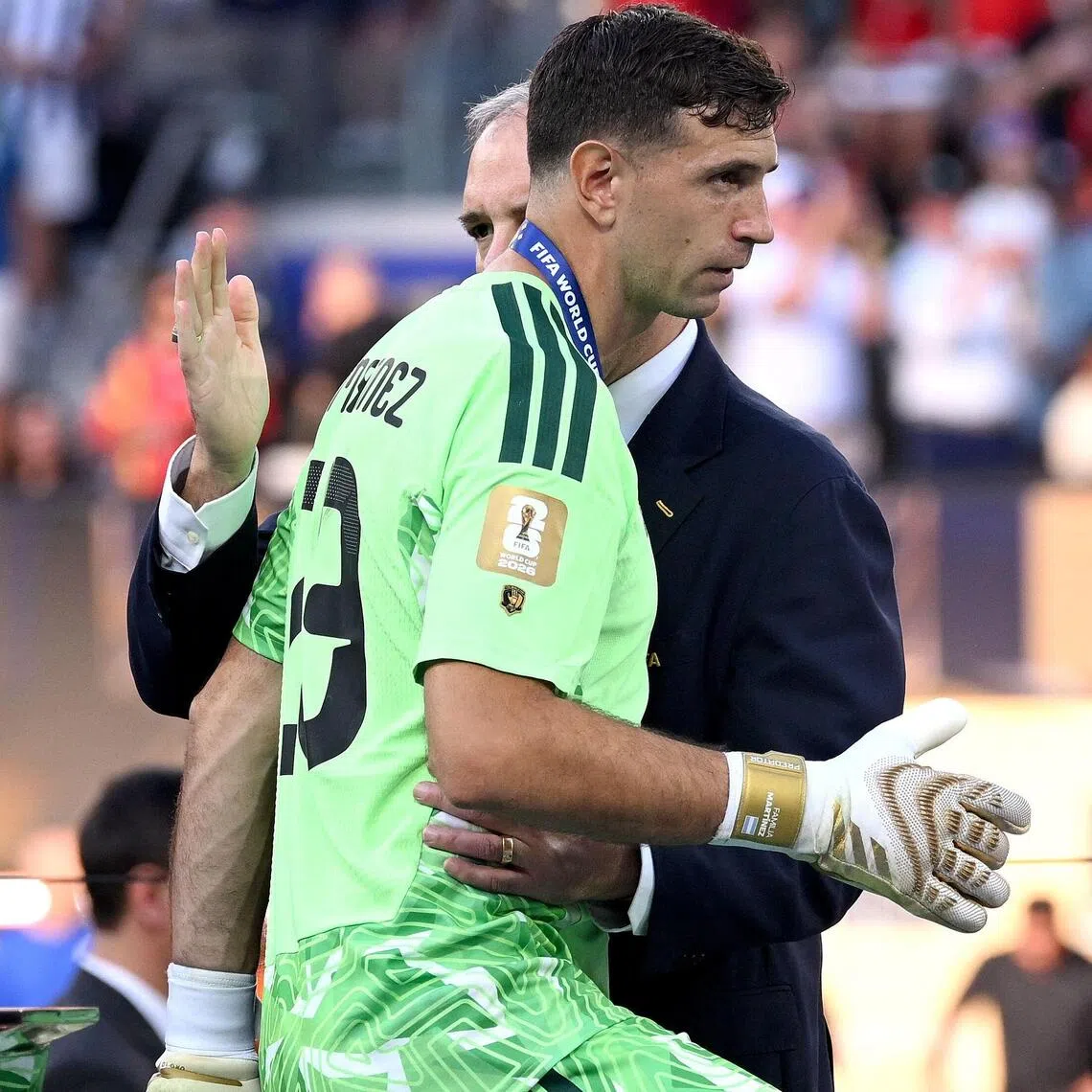 Emiliano Martinez of Argentina walking past the FIFA World Cup trophy at the award ceremony on July 19. The Aston Villa goalkeeper played 810 minutes at the tournament.