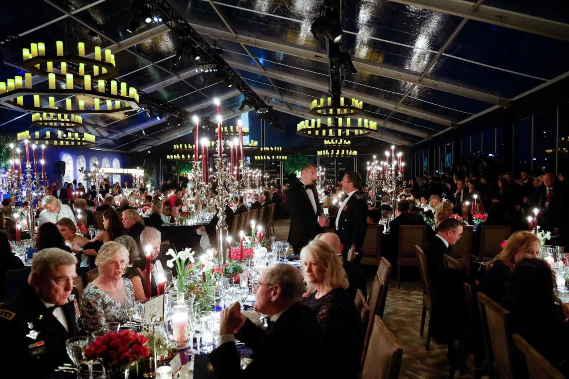 Chairman of the Join Chiefs of Staff General Mark A. Milley and others attend a state dinner for French President Emmanuel Macron on the South Lawn of the White House December 1, 2022, in Washington, DC. (Photo by Ludovic MARIN / AFP)