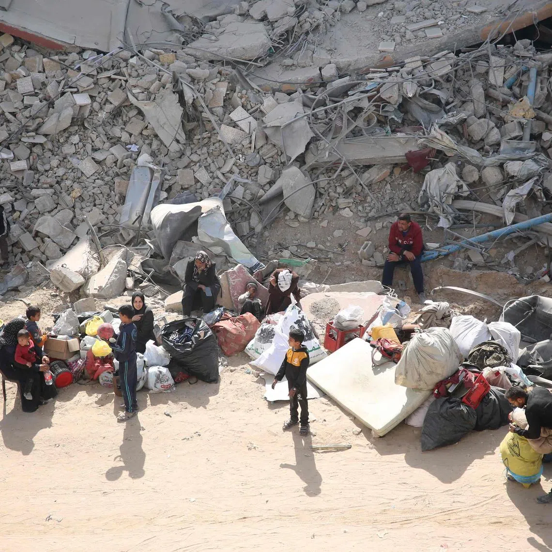 Palestinians inspect the damage in the area around Gaza's Al-Shifa hospital after the Israeli military withdrew on April 1, 2024, amid the ongoing battles Israel and the Hamas militant group. (Photo by AFP)