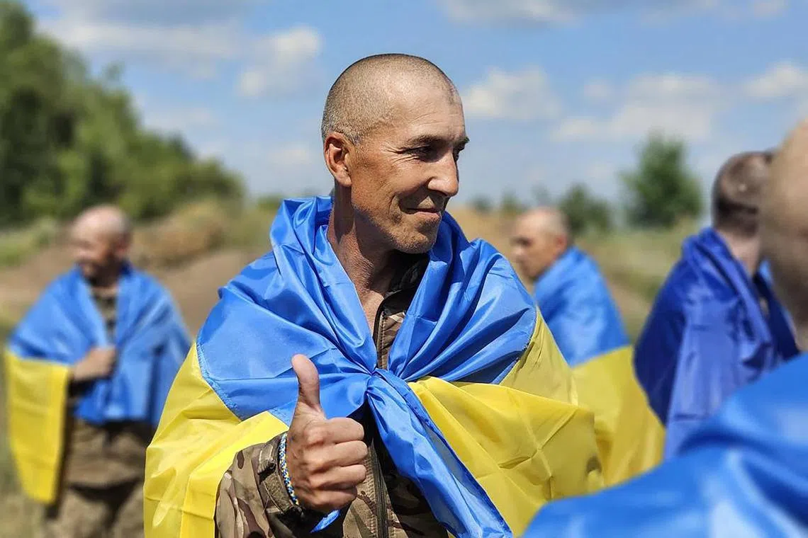 A Ukrainian prisoner of war gestures following a swap at an undisclosed location in Ukraine.