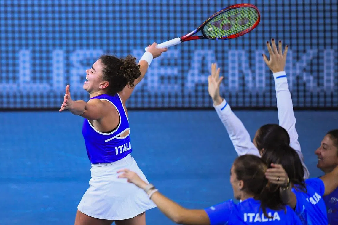 Italy's Jasmine Paolini (left) celebrates with her teammates after defeating Slovakia's Rebecca Sramkova.
