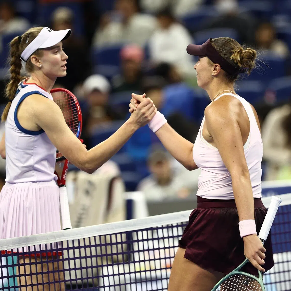 Armenia’s Alena Charaeva (right) and Kazakhstan’s Elena Rybakina shake hands after their last-64 match at tennis’ China Open in Beijing on Oct 3.