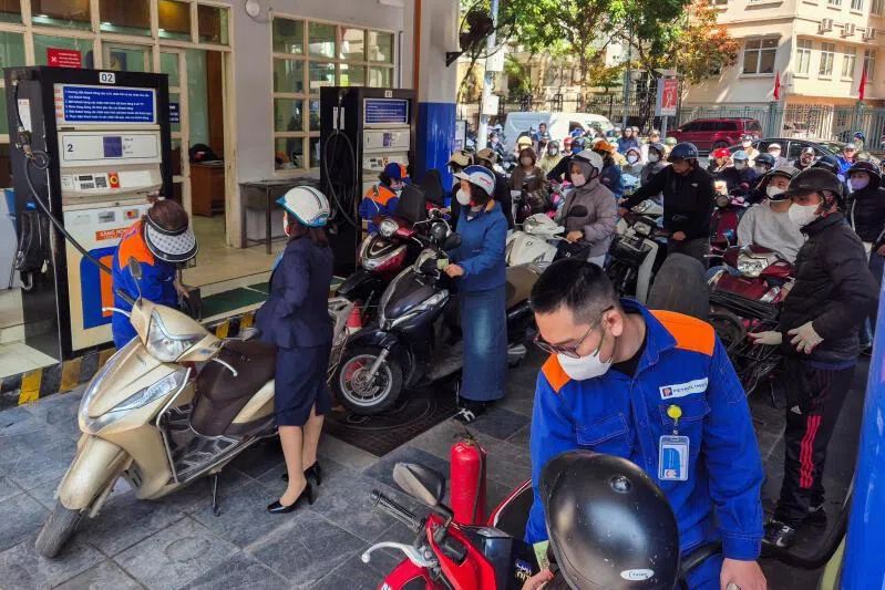 People queue to buy petrol at a petrol station after Vietnam's trade ministry called on local businesses to encourage their employees to work from home to save fuel amid disruptions in supply and price surges triggered by the U.S.-Israeli conflict with Iran, in Hanoi, Vietnam, March 10, 2026.