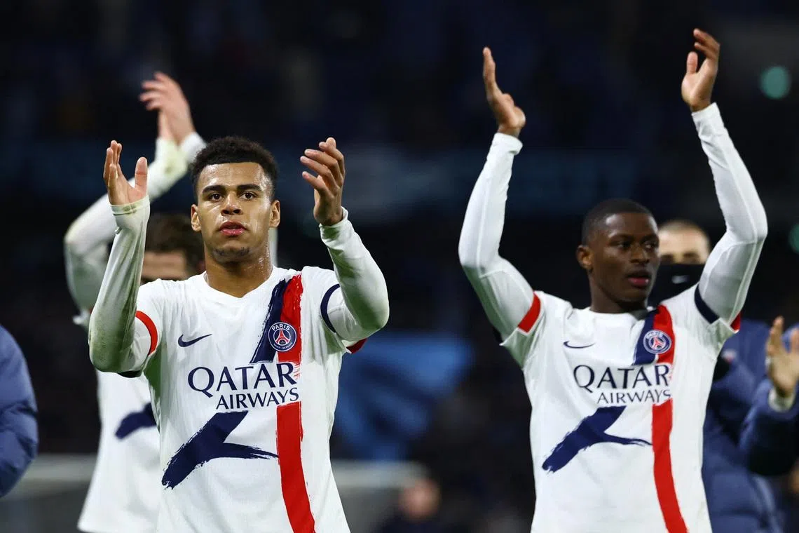 Soccer Football - Ligue 1 - Le Havre AC v Paris St Germain - Stade Oceane, Le Havre, France - February 28, 2026 Paris St Germain's Desire Doue applauds fans after the match with Nuno Mendes REUTERS/Sarah Meyssonnier