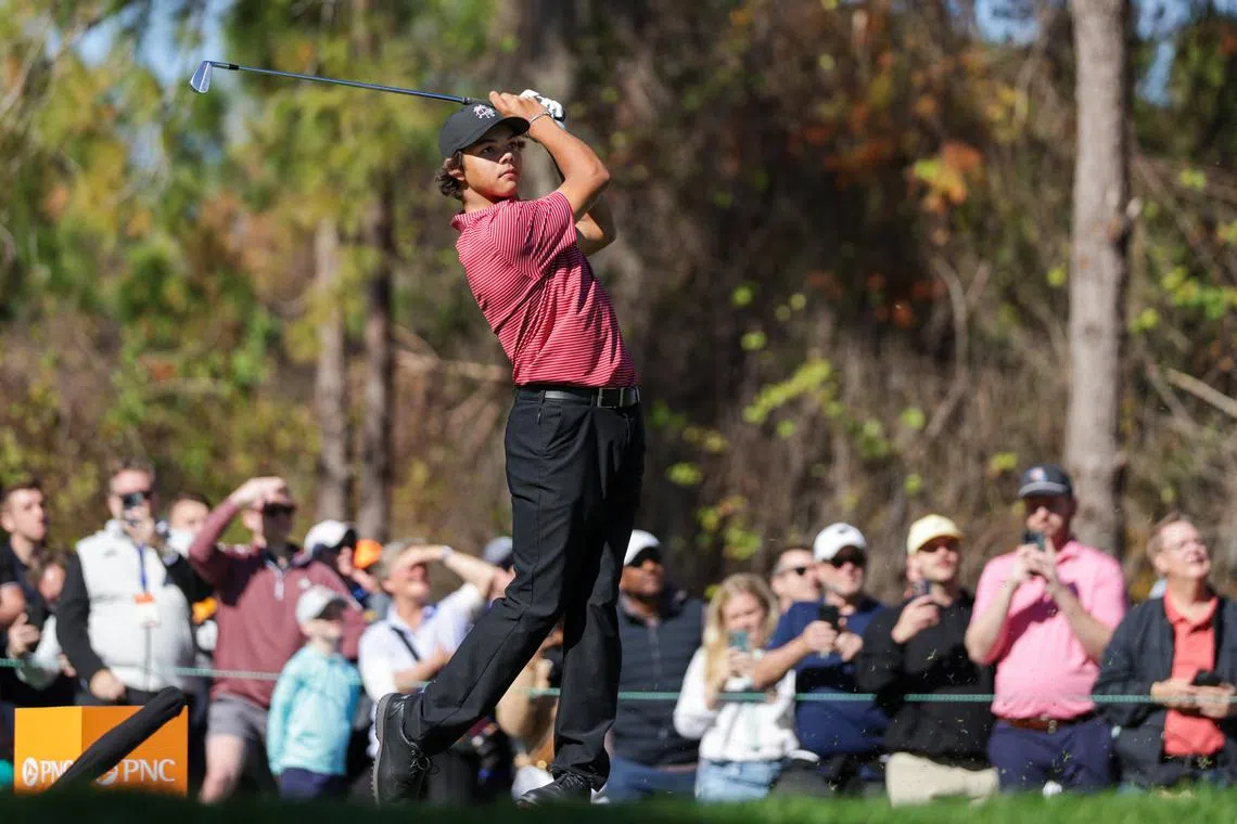 FILE PHOTO: Dec 22, 2024; Orlando, Florida, [USA]; Charlie Woods hits a hole in one on the fourth hole during the PNC Championship at The Ritz-Carlton Golf Club. Mandatory Credit: Nathan Ray Seebeck-Imagn Images