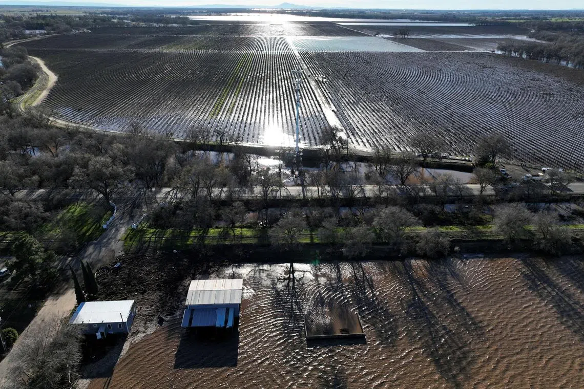An aerial view of flooded buildings and farmland after rainstorms caused a levee to break, flooding Sacramento County roads and properties near Wilton, California, U.S., January 1, 2023.  REUTERS/Fred Greaves