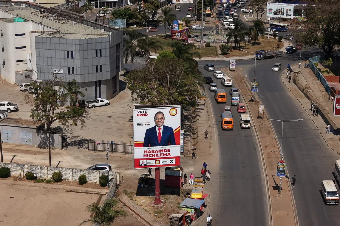 A drone view shows a campaign billboard for Zambian President Hakainde Hichilema, ahead of the country's general election on August 13, along a road in central Lusaka, Zambia, August 8, 2026. REUTERS/Moses Mwape