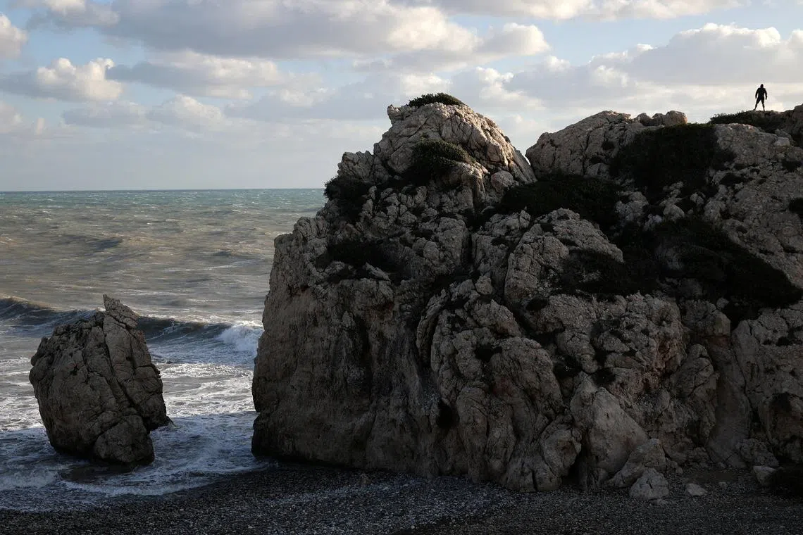 A man stands at Petra tou Romiou (Romios' Stone) beach, which according to myth is the birthplace of Aphrodite, the ancient Greek goddess of love and beauty, near Paphos, Cyprus November 27, 2023. REUTERS/Yiannis Kourtoglou     TPX IMAGES OF THE DAY