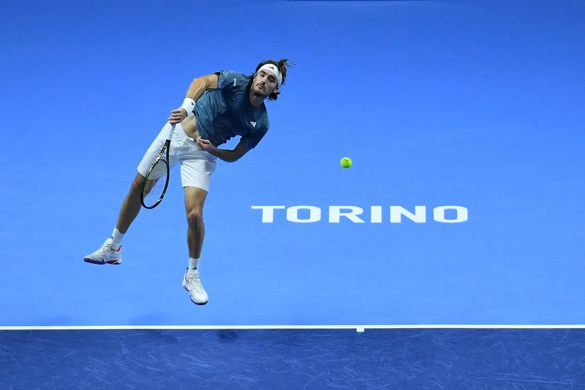 Greece's Stefanos Tsitsipas serving to Italy's Jannik Sinner during their first round-robin match at the ATP Finals tennis tournament on Nov 12, 2023 in Turin, Italy.