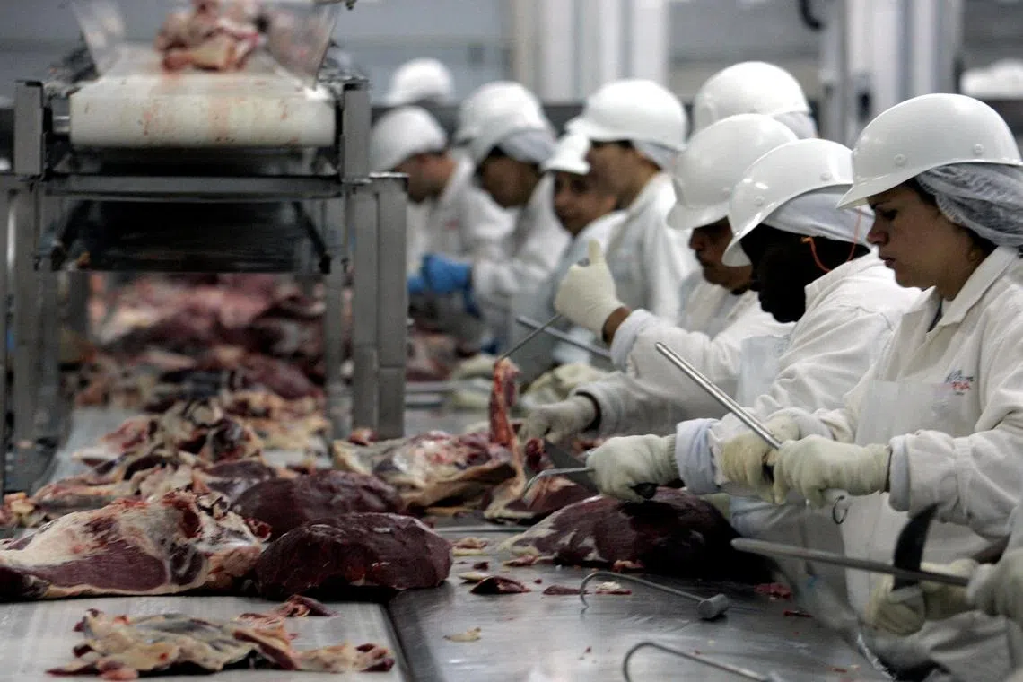 FILE PHOTO: Butchers chop meat at a packing plant in Sao Paulo in this September 9, 2005 file photo. REUTERS/Paulo Whitaker/File Photo