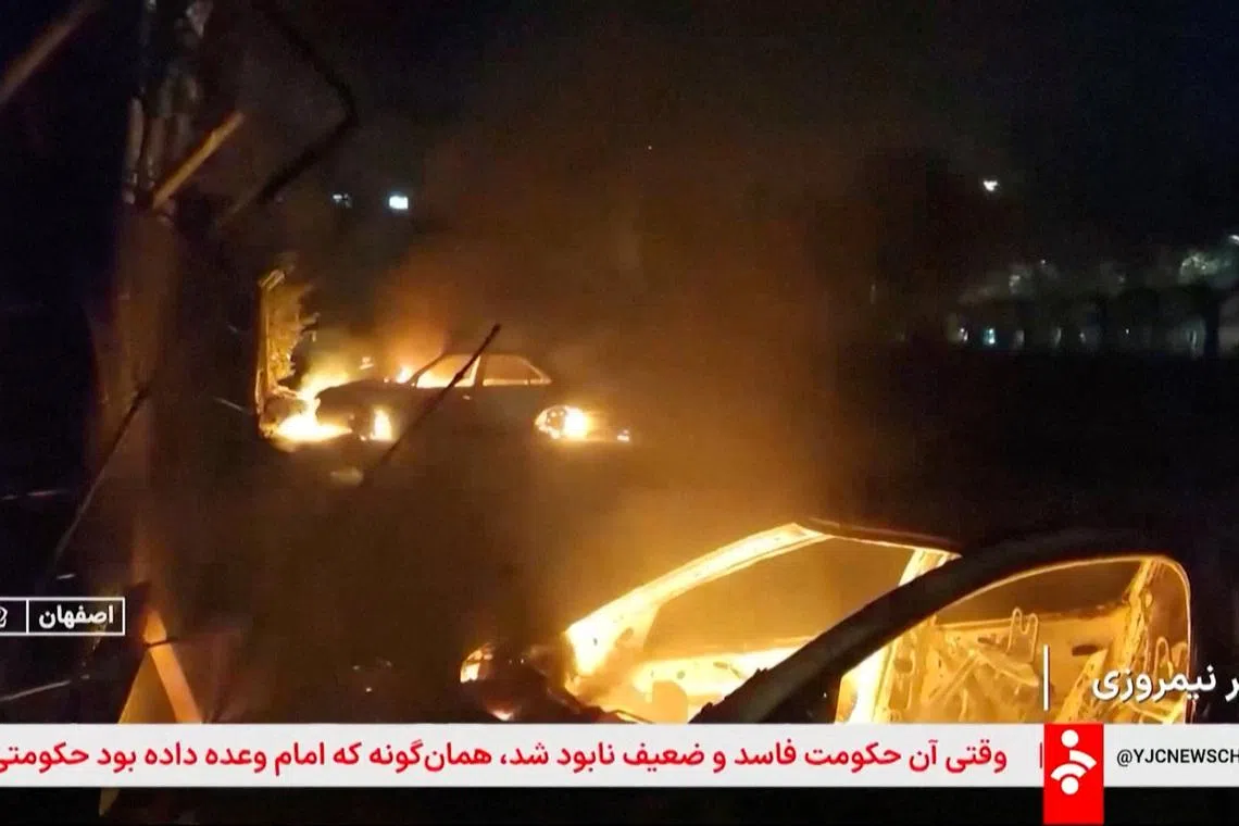 Flames engulf cars following unrest sparked by dire economic conditions, in a place given as Isfahan, Iran, January 9, 2026, in this screengrab from Iran's state media broadcast footage. IRIB via WANA(West Asia News Agency) via REUTERS